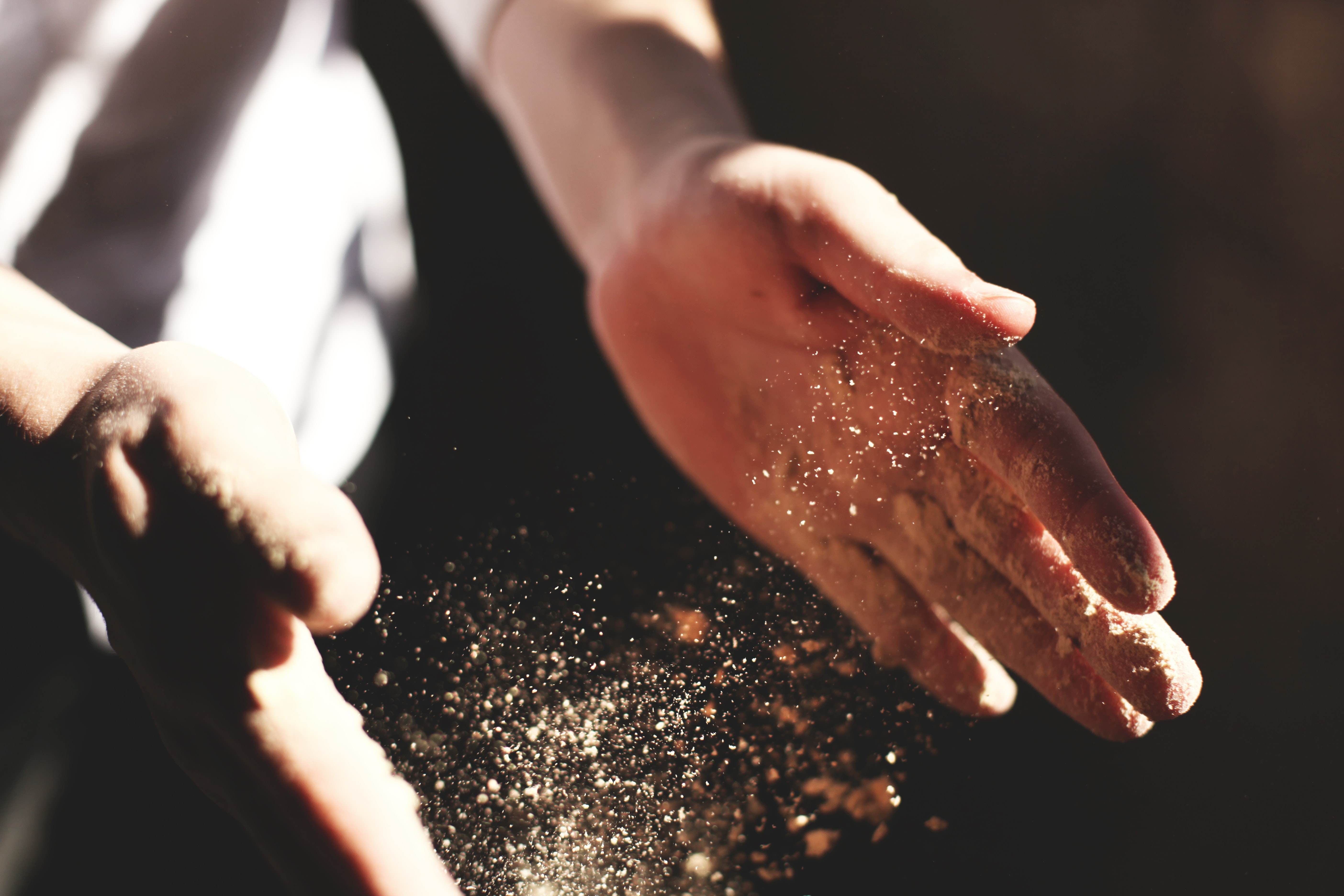 person's hands with dust