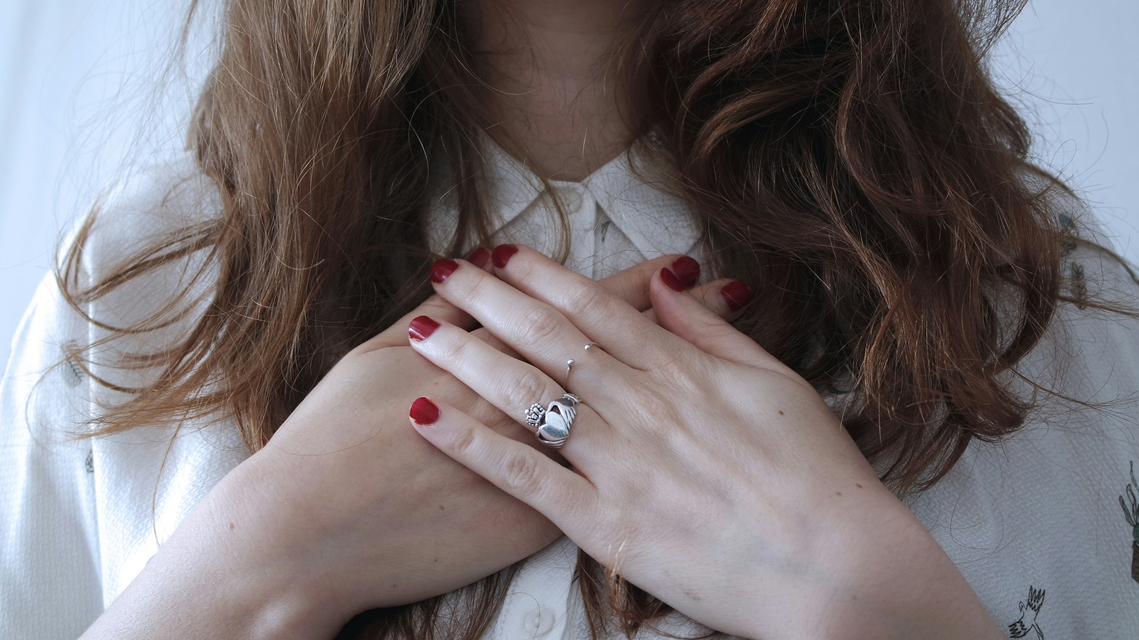 woman with hands over chest